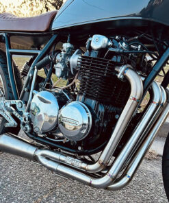 Side view of Murray's Carbs on a Honda CB550 motorcycle that has been converted to a caferacer.