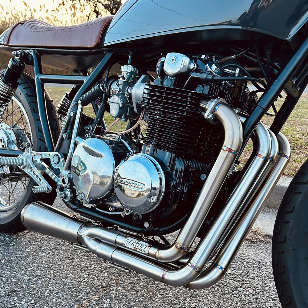 Side view of Murray's Carbs on a Honda CB550 motorcycle that has been converted to a caferacer.