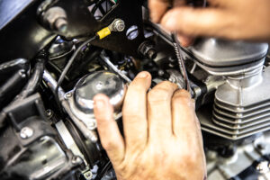 This shows loosening the intake bolts on a Triumph Speedmaster America.