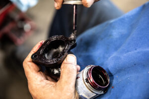 Applying grease to the o-rings for Murray's custom tuned Triumph motorcycle intake manifolds. 