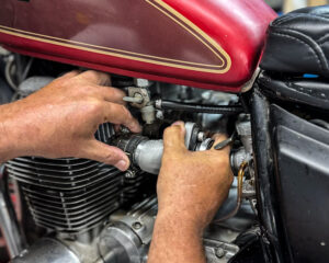 Pressing in Murray's high flow custom tuned aluminum intake manifolds on a Honda CB650 cafe racer. 