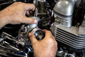 Applying grease to the back of the Mikuni carburetors.