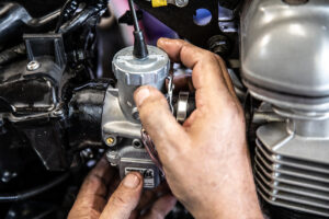 Pressing Murray's air box adapters into the air box on a Triumoh America Speedmaster 790 or 865. 