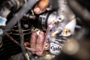 Twisting the Mikuni spigot into place during the install of Murray's Carbs.