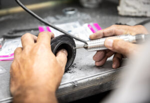 Making pilot holes in the pod filters of Murray's Carburetor kit in order to drill a hole for our barbed fittings. 
