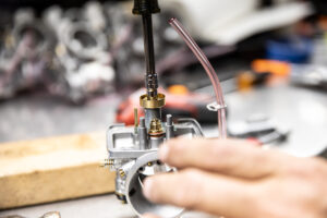 Removing the main jet and fuel defuser from a Mikuni VM series carburetor. 