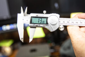 Vernier caliper locked at 13mm to measure idle screws on a Murray's Carburetor Kit. 