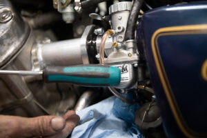 Tapping the float bowl while draining the fuel to dislodge any debris stuck between the float needle and seat. 